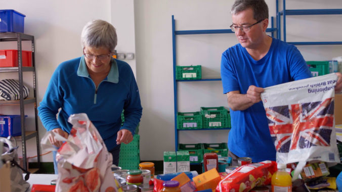 Team organizing food supplies captured as part of a charity video production