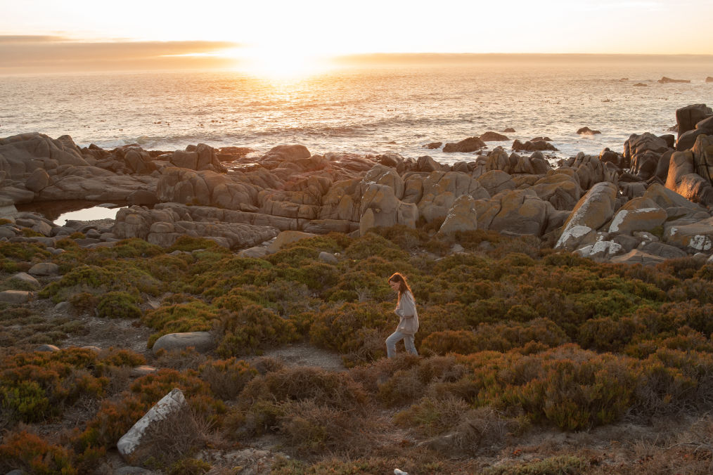 Filmmaker adjusting camera settings during a brand video shoot.