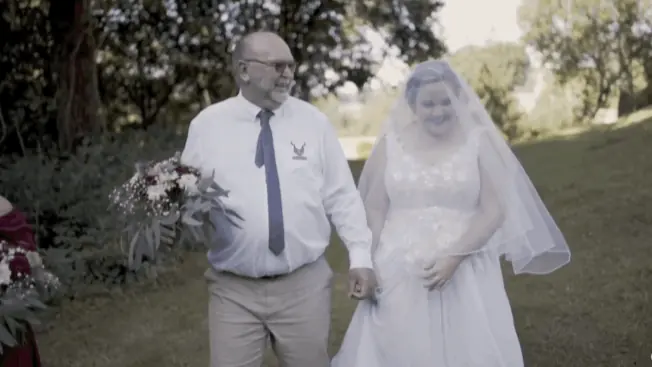 walking through the field towards the aisle filmed by wedding videographer Portugal