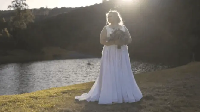 bride filmed by wedding videographer Portugal whilst overlooking dam