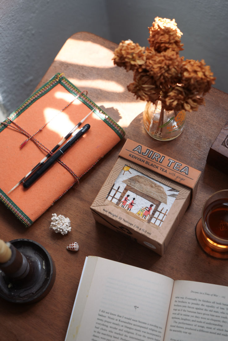 Product photography of tea box with book and flowers