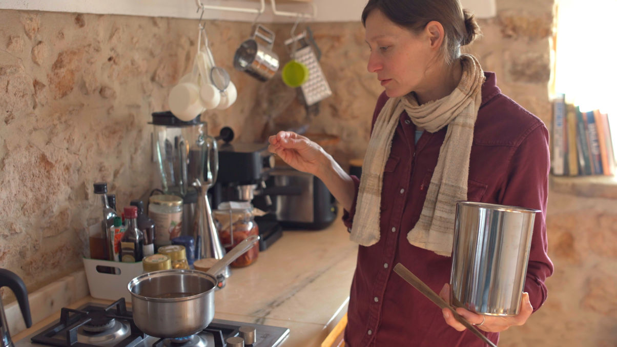 Olivia creating herbal products in the kitchen 