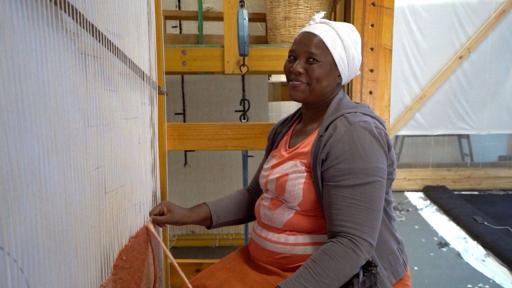 weaver smiling at loom